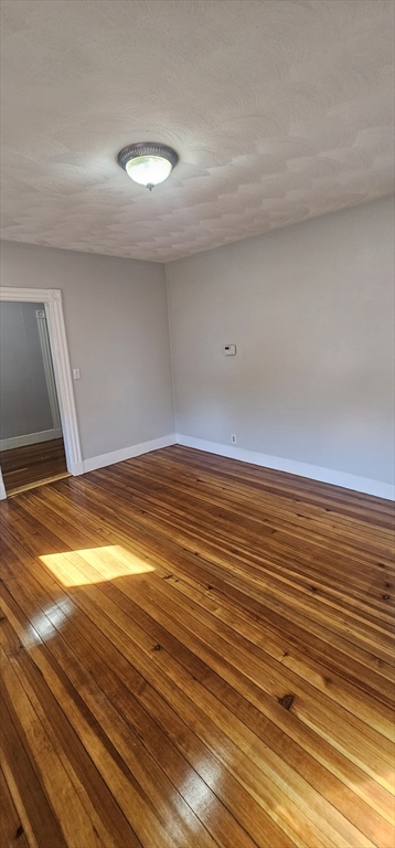 169 Colburn Street, Unit 1 Dedham, MA 02026 - Photo 2 of 12 a view of empty room with wooden floor