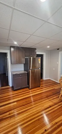 a view of a room with wooden floor