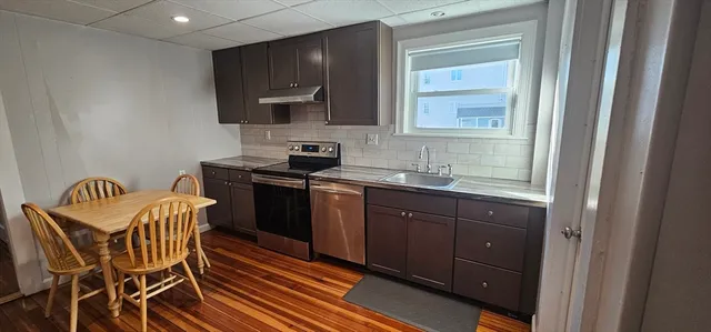 a kitchen with granite countertop wooden cabinets and a granite counter tops
