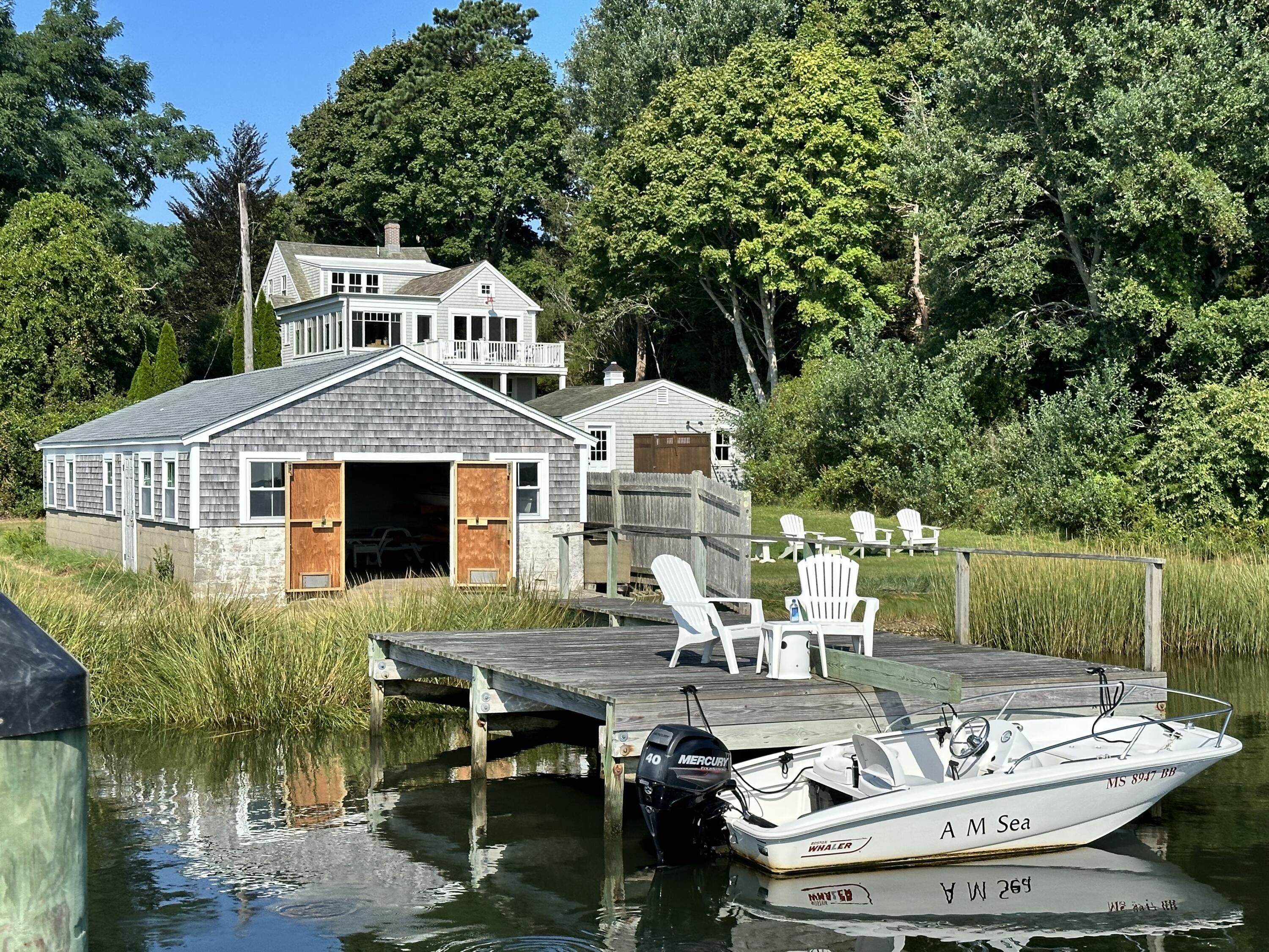 28 Little River Road Cotuit, MA 02635 - Photo 1 of 17 a front view of a house with swimming pool