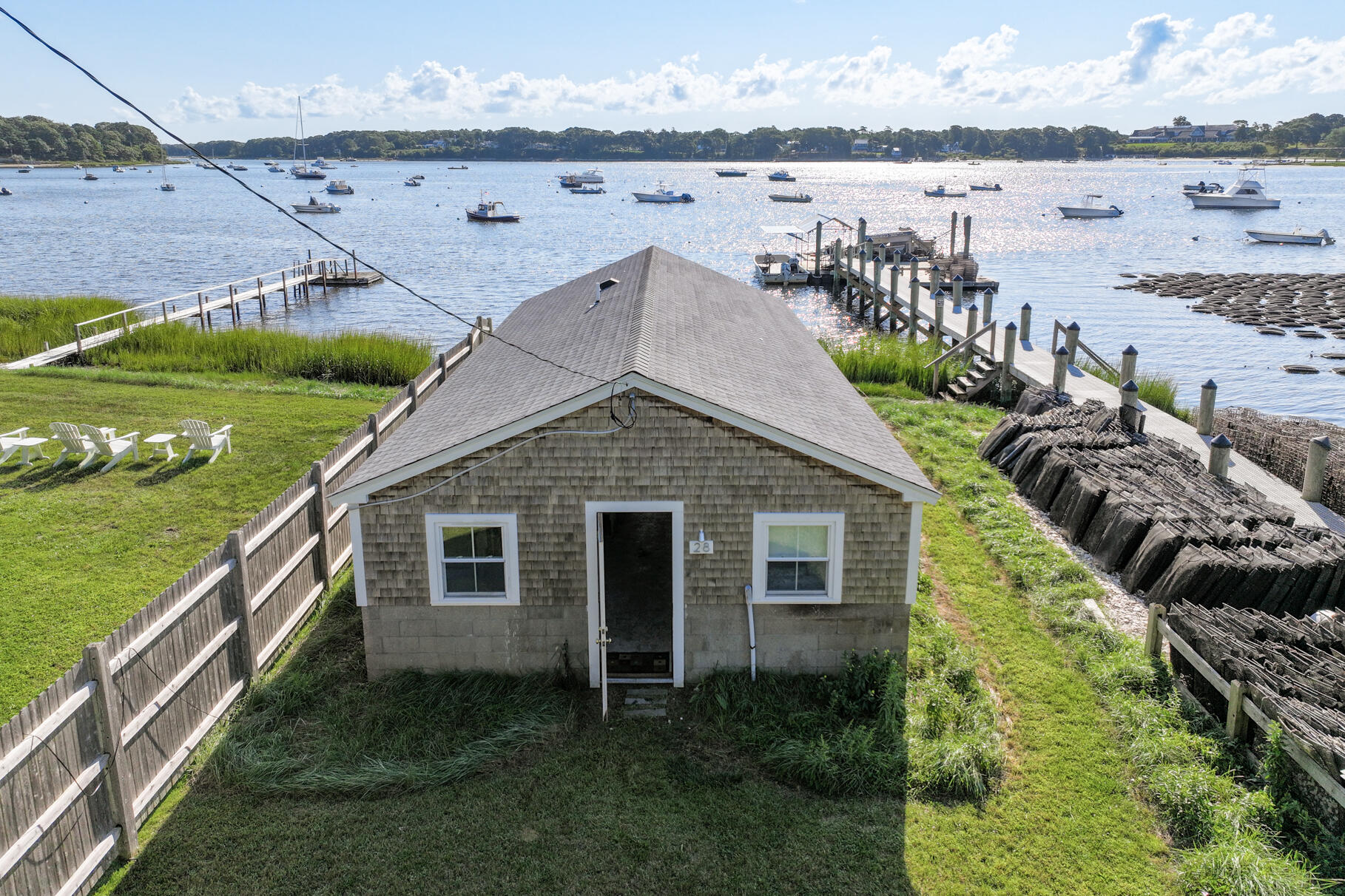 28 Little River Road Cotuit, MA 02635 - Photo 8 of 17 a aerial view of a house with a yard and lake view