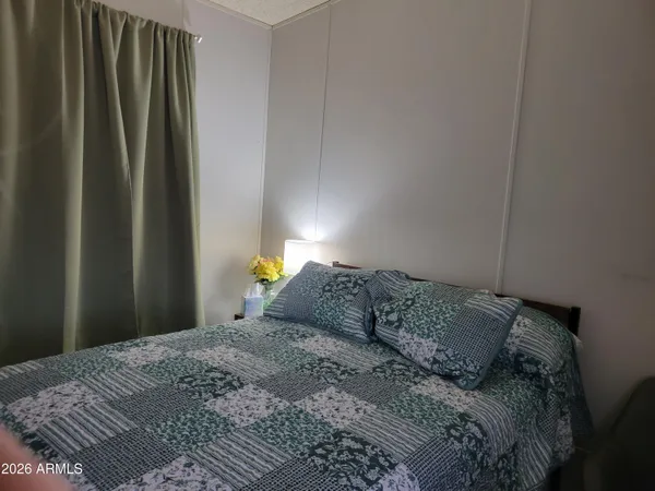 a bedroom with a bed and a window