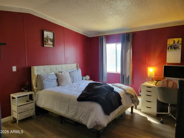 a bedroom with a bed and a night stand