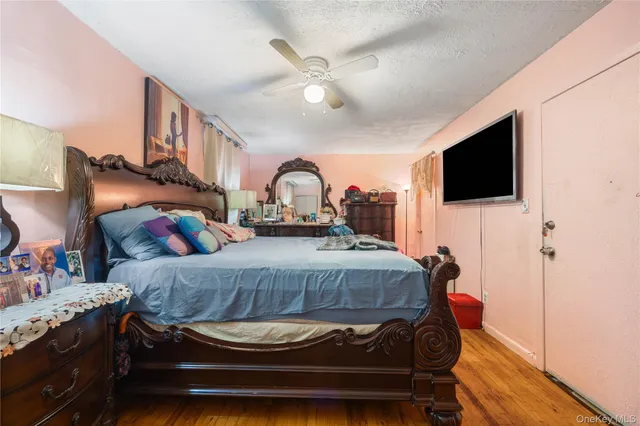 a bedroom with a bed and flat screen tv