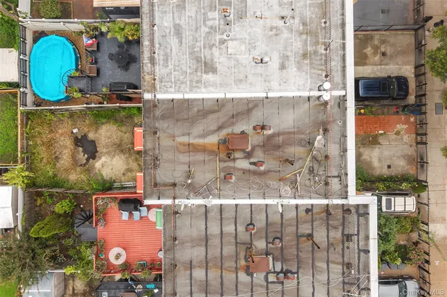 a view of a swimming pool with outdoor seating and plants
