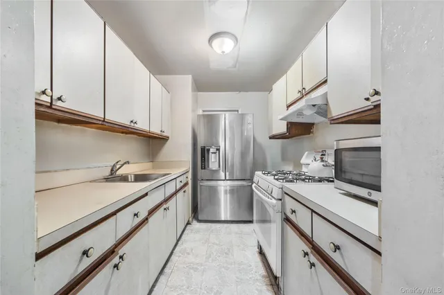 a kitchen with a sink stove and refrigerator