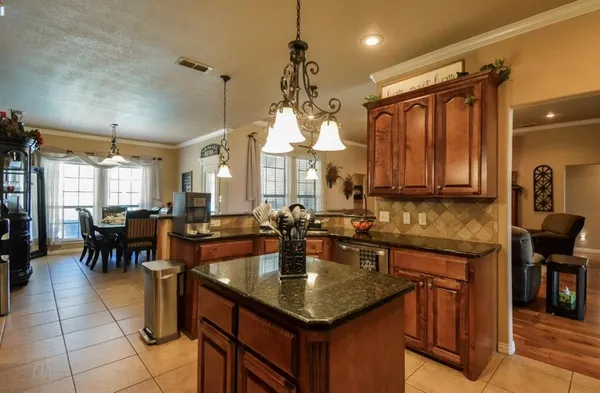 a kitchen with center island table and chairs in it