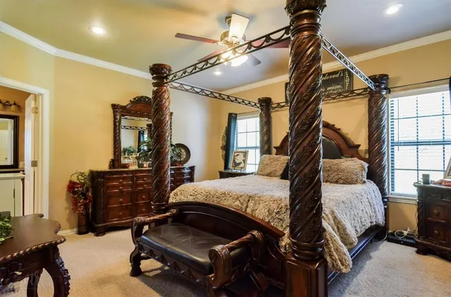 a bedroom with a bed gym equipment and a large window