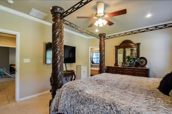 a bedroom with a bed and a mirror on the dresser