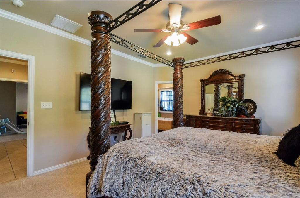 2457 Highway 83 Tuscola, TX 79562 - Photo 17 of 40 a bedroom with a bed and a mirror on the dresser