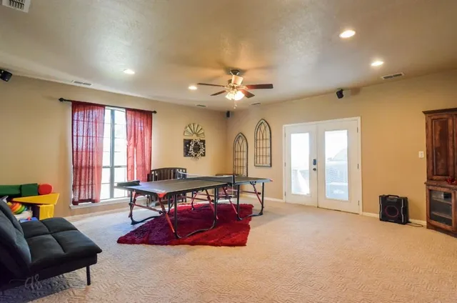 a living room with furniture a table and a flat screen tv