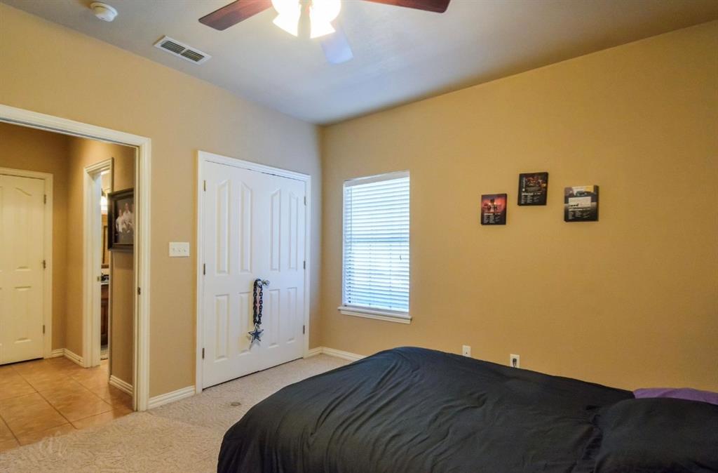 2457 Highway 83 Tuscola, TX 79562 - Photo 26 of 40 a bedroom with a bed and a chandelier fan