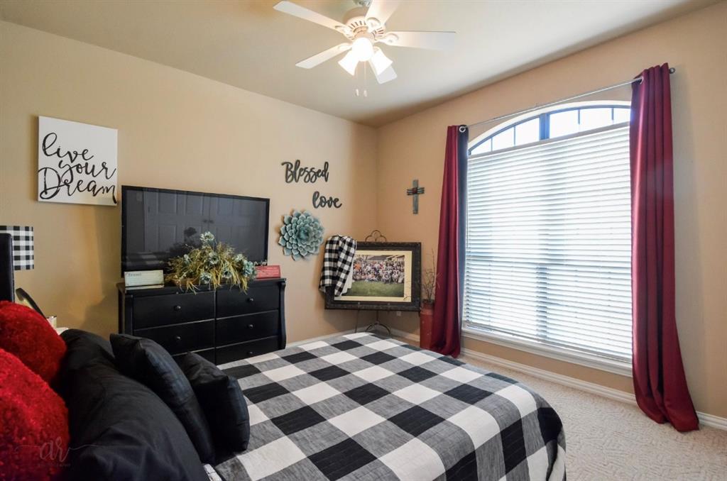 2457 Highway 83 Tuscola, TX 79562 - Photo 30 of 40 a bedroom with a bed and dresser with mirror