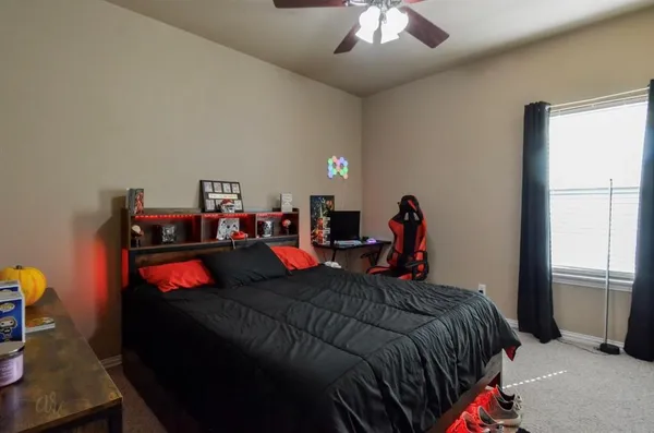 a bed room with a bed and a chandelier