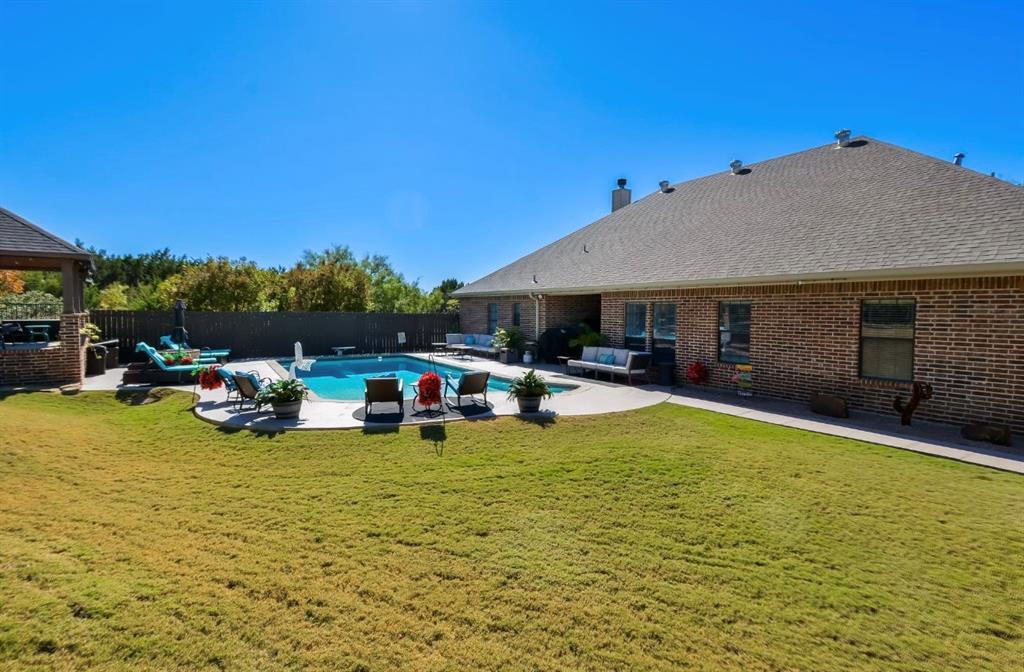 2457 Highway 83 Tuscola, TX 79562 - Photo 37 of 40 a view of swimming pool with table and chairs under an umbrella
