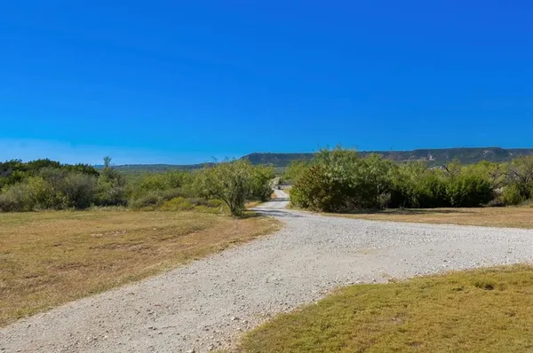 a view of a field with an ocean
