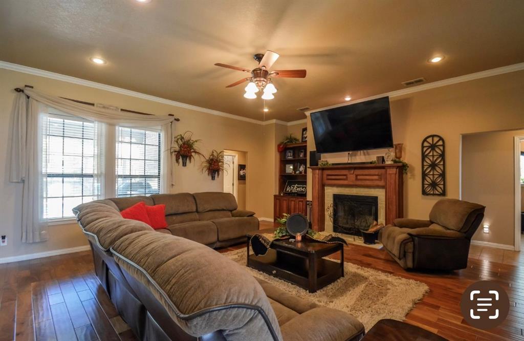 2457 Highway 83 Tuscola, TX 79562 - Photo 6 of 40 a living room with furniture a flat screen tv and a fireplace
