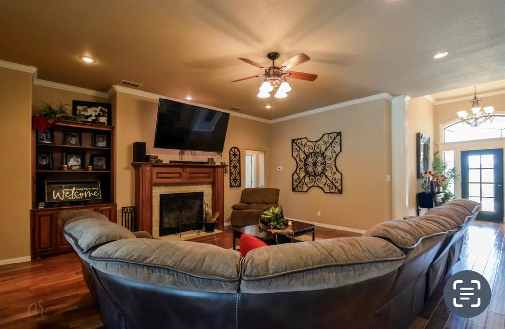 2457 Highway 83 Tuscola, TX 79562 - Photo 7 of 40 a living room with furniture a flat screen tv and a fireplace