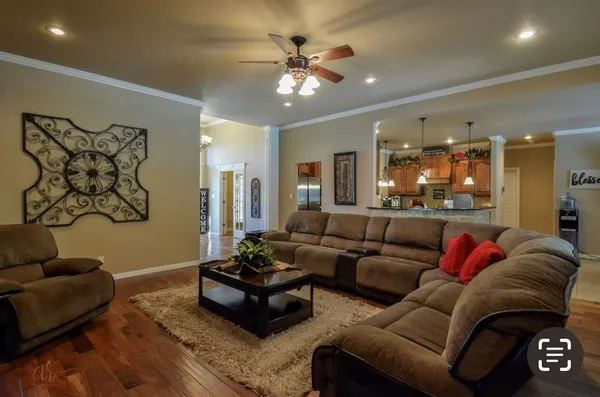 a living room with furniture and a chandelier