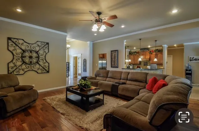 a living room with furniture and a chandelier