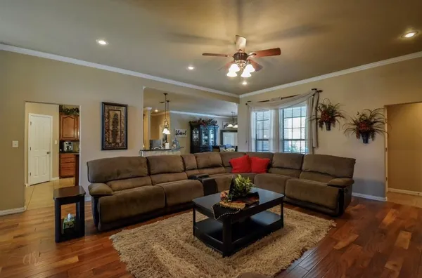 a living room with furniture and wooden floor