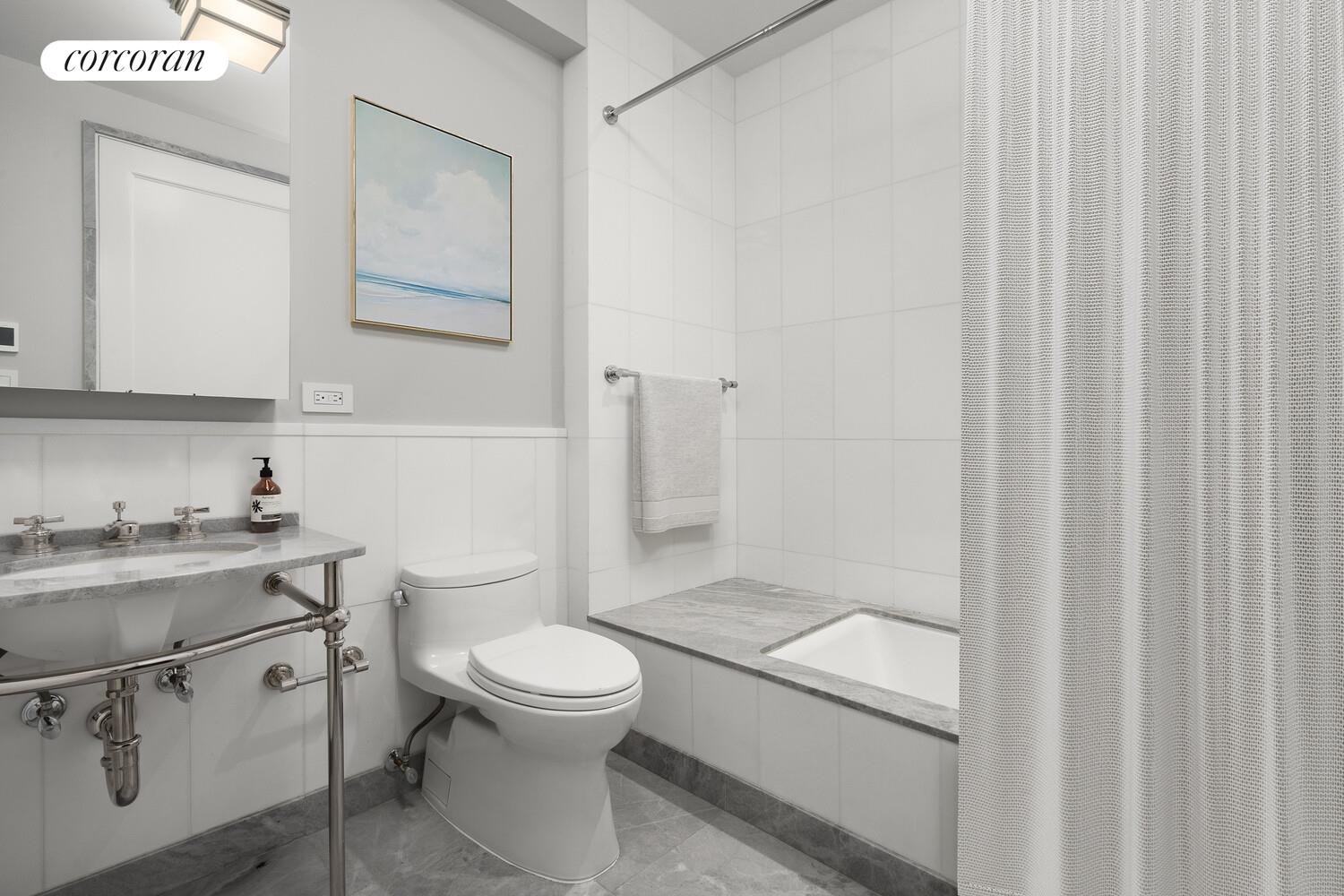 40 East 72nd Street, Unit MAIS Manhattan, NY 10021 - Photo 10 of 16 a bathroom with a granite countertop toilet a sink and a mirror