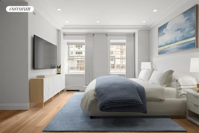 a spacious bedroom with a bed and a flat screen tv