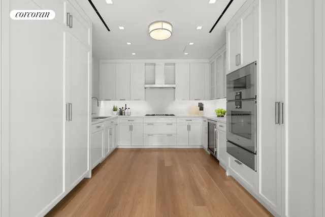 a kitchen with a refrigerator and white cabinets