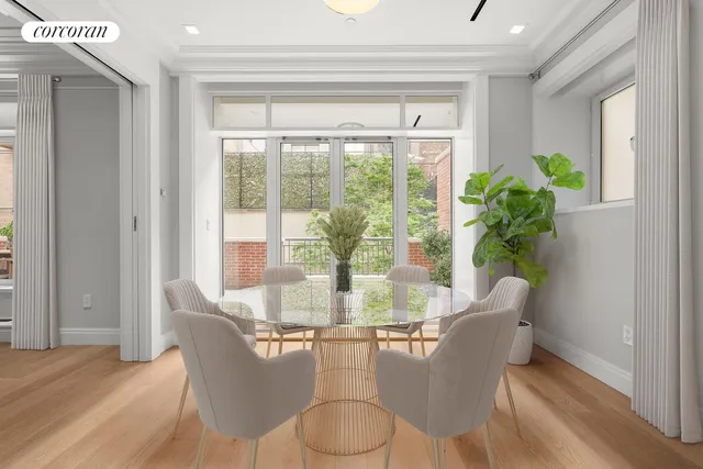 a dining room with furniture window and wooden floor