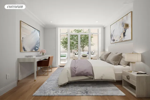 a bedroom with a bed and a large mirror on the dresser