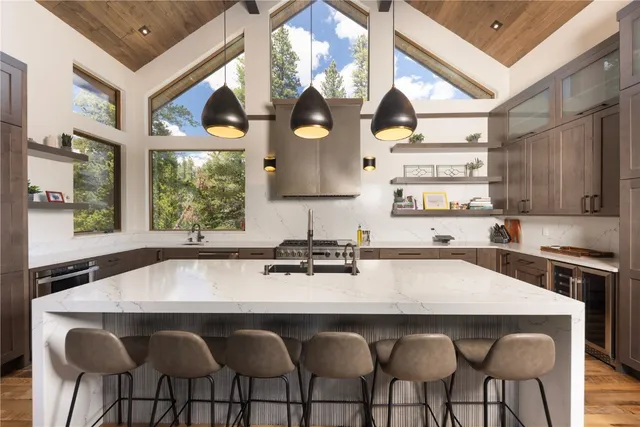 a kitchen with a table chairs stove and cabinets