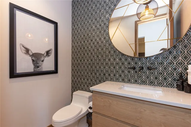 a bathroom with a toilet and a mirror