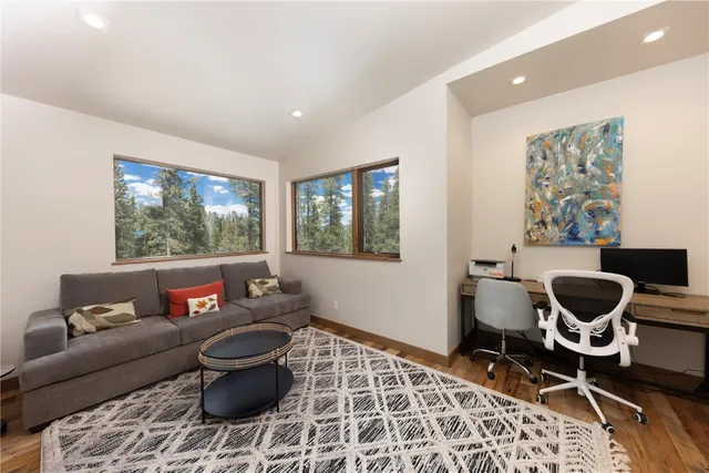 a living room with furniture a rug and a window