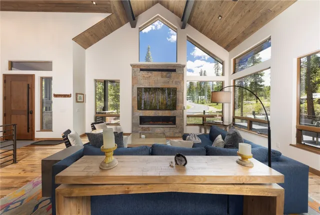 a view of a kitchen with kitchen island a large window cabinets a sink and stainless steel appliances