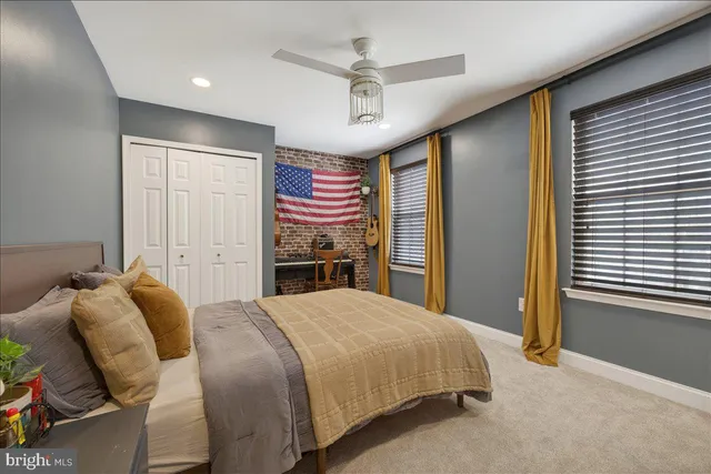 a bedroom with a bed dresser and a window