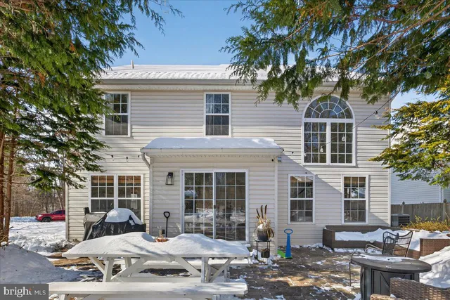 a view of a patio with a table and chairs and potted plants