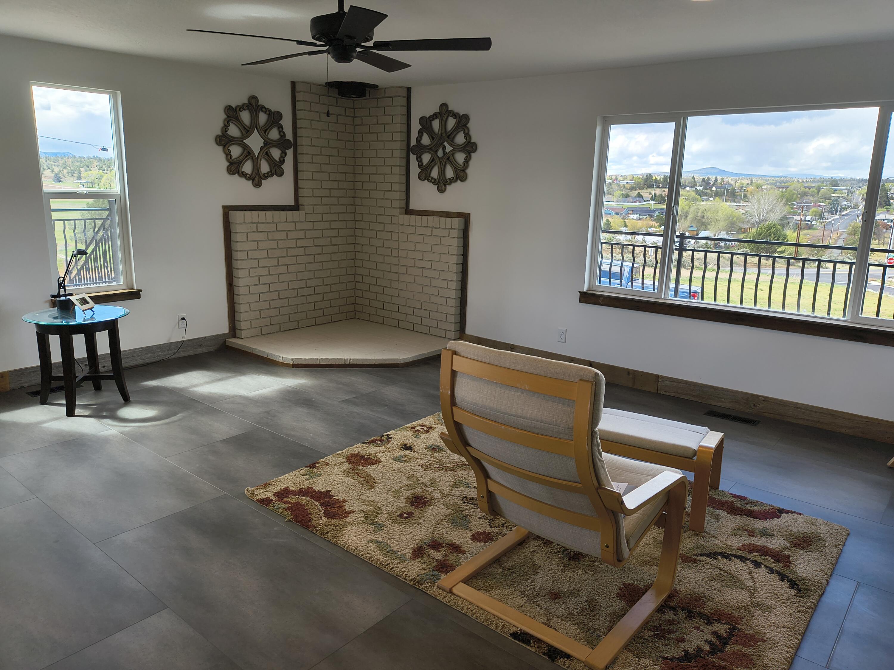 791 Southeast Grizzly Road Madras, OR 97741 - Photo 10 of 31 a living room with couch chairs and a window