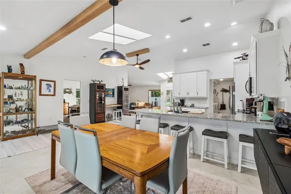 a kitchen with stainless steel appliances kitchen island granite countertop a refrigerator and a stove top oven