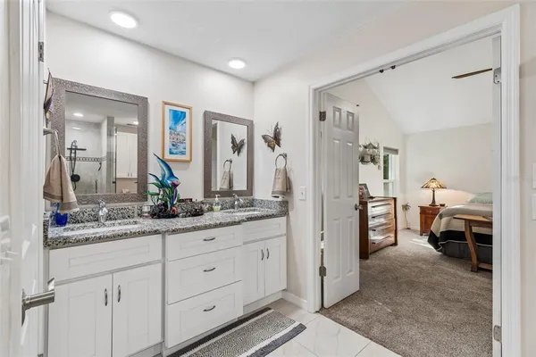 a bedroom with a large bed and ceiling fan