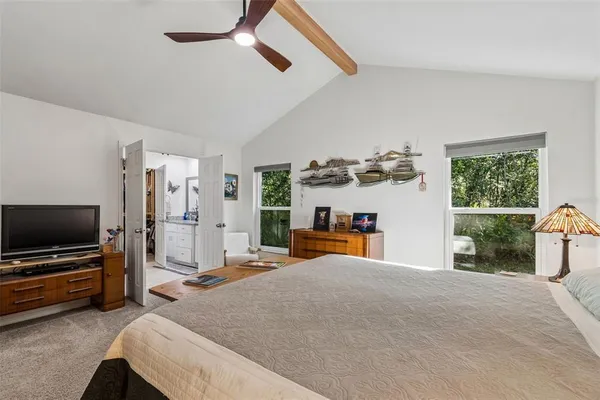 a kitchen with stainless steel appliances granite countertop a stove top oven a sink dishwasher and white cabinets with wooden floor