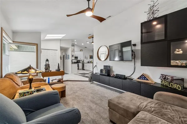 a kitchen with granite countertop a sink stainless steel appliances and white cabinets