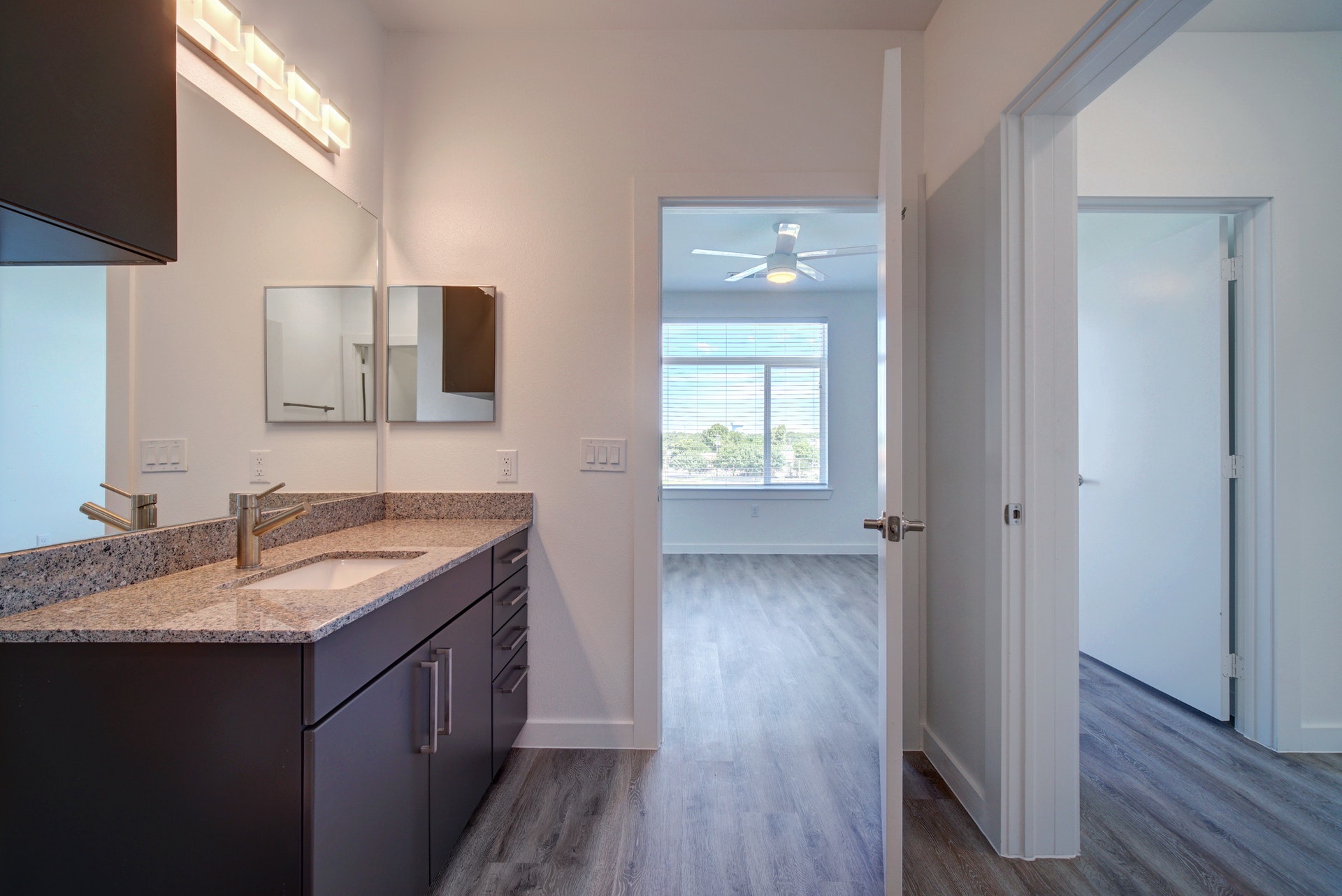 13130 Pond Springs Road, Unit 3214 Austin, TX 78729 - Photo 20 of 40 Bathroom featuring dark wood-style floors, vanity, and a ceiling fan