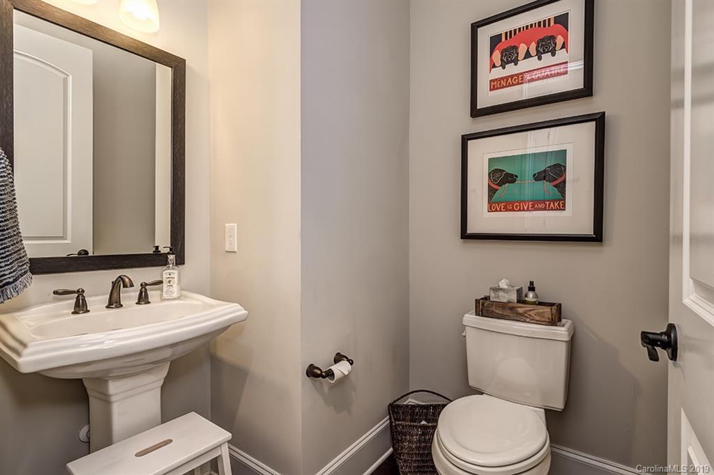 661 Zinnia Way Tega Cay, SC 29708 - Photo 14 of 35 a bathroom with a toilet a sink and mirror