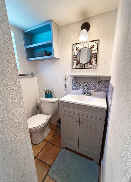 4225 Bradenton Road, Unit C Sarasota, FL 34234 - Photo 11 of 19 a bathroom with a toilet a sink and mirror