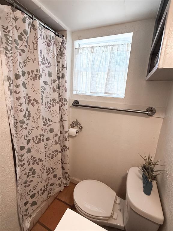 4225 Bradenton Road, Unit C Sarasota, FL 34234 - Photo 12 of 19 a bathroom with a toilet and a shower curtain