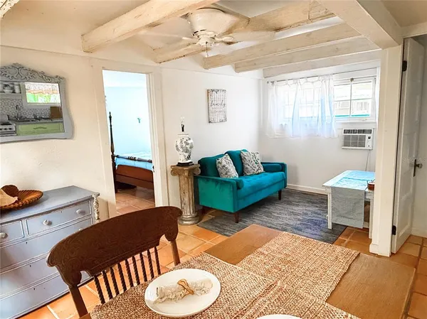 a living room with furniture a rug and a window