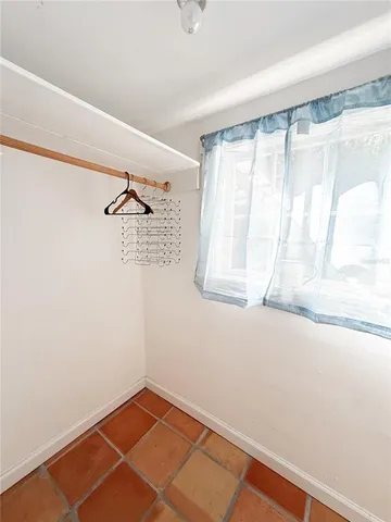 a view of a room with a window and closet