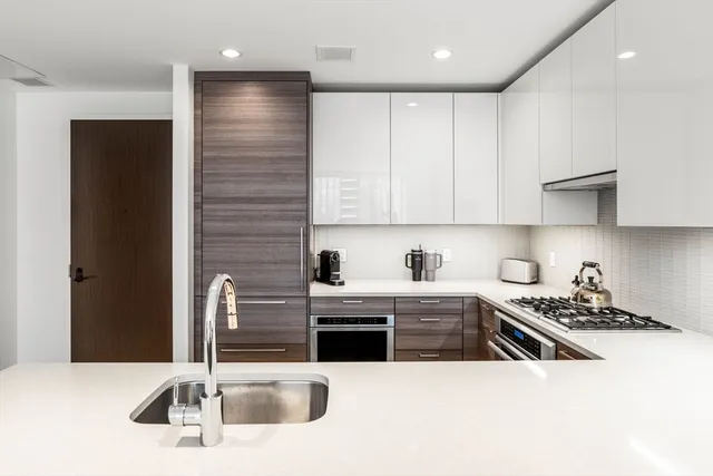 a kitchen with stainless steel appliances kitchen island granite countertop a sink and cabinets