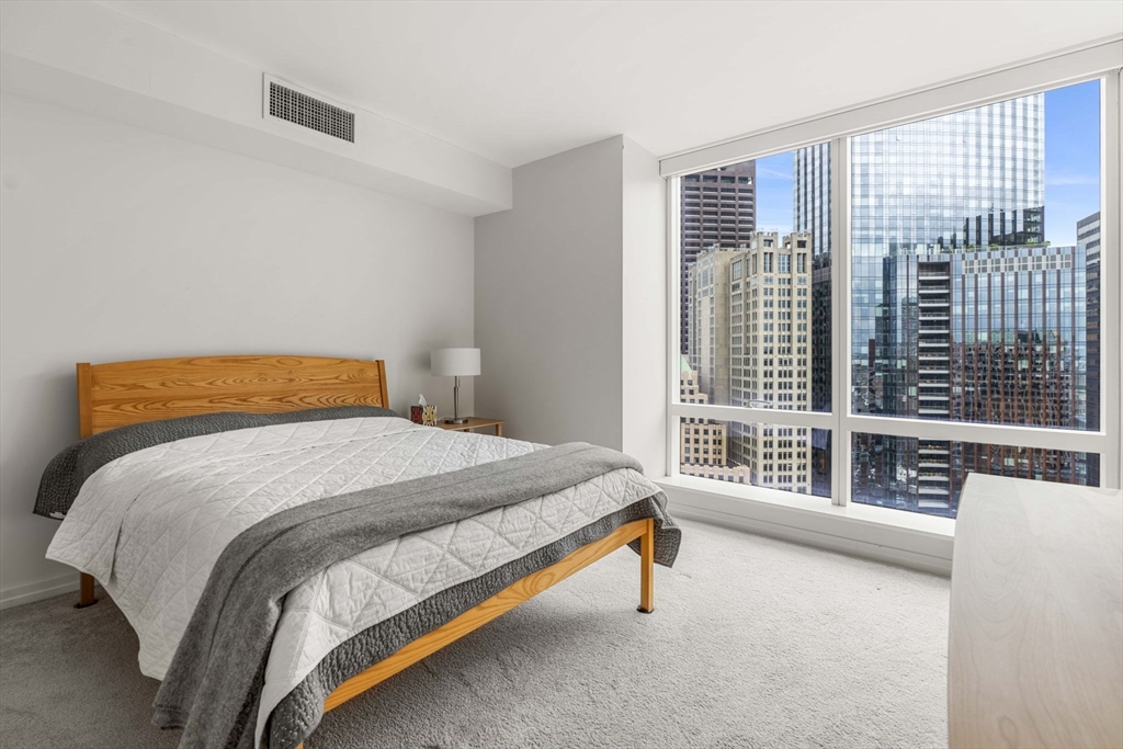 1 Franklin Street, Unit 2609 Boston, MA 02110 - Photo 14 of 24 a bedroom with a bed and a large window