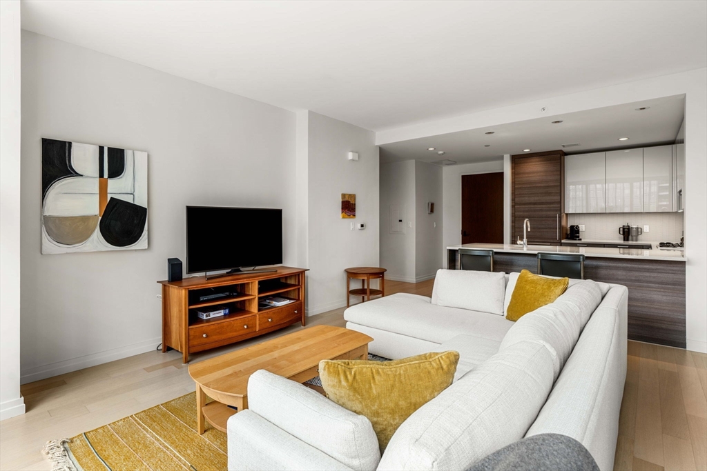 1 Franklin Street, Unit 2609 Boston, MA 02110 - Photo 2 of 24 a living room with furniture and a flat screen tv